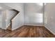 An open concept living room space with hardwood floors with stairs visible at 208 Oconee Way, Canton, GA 30114