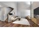 Bright living area showcasing hardwood floors and modern design elements, with a staircase in view at 208 Oconee Way, Canton, GA 30114
