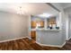 An open concept living space shows hardwood floors with the kitchen in view at 208 Oconee Way, Canton, GA 30114