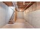 Unfinished basement featuring concrete flooring, exposed beams, and stairs at 260 Pleasant Grove Cir, Mcdonough, GA 30252