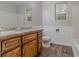 Bathroom featuring wood-look floors, granite counters, and white cabinets at 260 Pleasant Grove Cir, Mcdonough, GA 30252