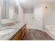 Well-lit bathroom featuring double sinks, granite countertop, a tub and shower combo at 260 Pleasant Grove Cir, Mcdonough, GA 30252
