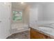 Bathroom features a jetted tub, granite countertop vanity, and wood-look floors at 260 Pleasant Grove Cir, Mcdonough, GA 30252