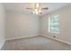 Comfortable bedroom featuring plush carpet, bright window, and neutral color palette at 260 Pleasant Grove Cir, Mcdonough, GA 30252