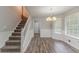 Cozy dining room with staircase, chandelier lighting, and large window at 260 Pleasant Grove Cir, Mcdonough, GA 30252