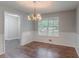Bright dining room with large window and chandelier lighting at 260 Pleasant Grove Cir, Mcdonough, GA 30252