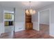 Elegant dining room showcasing a modern chandelier and direct view into the kitchen, perfect for entertaining at 260 Pleasant Grove Cir, Mcdonough, GA 30252