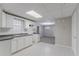 Spacious kitchen with white cabinets, tiled floor and backsplash, complemented by modern lighting fixtures at 260 Pleasant Grove Cir, Mcdonough, GA 30252