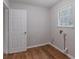 Laundry room with hardwood flooring and a window for natural light at 260 Pleasant Grove Cir, Mcdonough, GA 30252