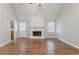 Spacious living room features a brick fireplace, hardwood floors, and access to the kitchen at 260 Pleasant Grove Cir, Mcdonough, GA 30252