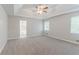 Spacious main bedroom features a tray ceiling, carpet, and an ensuite bathroom at 260 Pleasant Grove Cir, Mcdonough, GA 30252