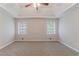 Carpeted main bedroom features tray ceiling and a large window at 260 Pleasant Grove Cir, Mcdonough, GA 30252