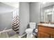 Clean bathroom with a shower, neutral tiles, and a vanity with sink, offering essential amenities for daily use at 502 Gallantry Trl, Mcdonough, GA 30252