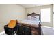 This bedroom features a bed with patterned bedding, carpeted floors, and a bright window for natural light at 502 Gallantry Trl, Mcdonough, GA 30252