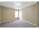 Neutral bedroom featuring plush carpeting, a window for natural light, freshly painted walls, and a white door at 502 Gallantry Trl, Mcdonough, GA 30252