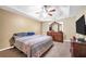 Serene bedroom featuring neutral tones, soft carpet, a tray ceiling, and ample space for relaxation and rest at 502 Gallantry Trl, Mcdonough, GA 30252