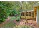 Well-maintained backyard featuring a screened-in porch, wood fencing, and mature trees at 9685 Cone Ct, Roswell, GA 30075