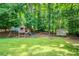 Lush backyard showcasing a playset, storage shed, and mature trees at 9685 Cone Ct, Roswell, GA 30075