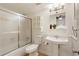 Bathroom featuring a shower-tub combo, white vanity, and frosted glass shower door at 9685 Cone Ct, Roswell, GA 30075