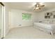 Large bedroom with neutral walls, carpet, and plenty of light from the window at 9685 Cone Ct, Roswell, GA 30075