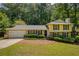 Charming two-story home with a well-manicured front yard, stone accents, and attached two-car garage at 9685 Cone Ct, Roswell, GA 30075