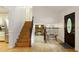 Inviting foyer with hardwood floors, staircase, and a view into the living room with a fireplace at 9685 Cone Ct, Roswell, GA 30075