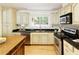 Updated kitchen featuring stainless steel appliances, granite countertops, ample cabinet space, and hardwood floors at 9685 Cone Ct, Roswell, GA 30075