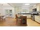 Modern kitchen with granite countertops, stainless steel appliances, a center island, and seamless access to the dining area at 9685 Cone Ct, Roswell, GA 30075