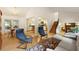 Spacious living room showcasing hardwood floors, comfortable seating, and a view of the kitchen and dining area at 9685 Cone Ct, Roswell, GA 30075