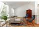 Bright living room with hardwood floors, vaulted ceiling, large windows, and a cozy seating area at 9685 Cone Ct, Roswell, GA 30075