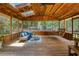 Wood porch with comfortable seating, ceiling fans, skylights, and a porch swing for outdoor living at 9685 Cone Ct, Roswell, GA 30075