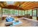 A stunning wood porch with ceiling fans, skylights, a porch swing, and comfortable seating for relaxation at 9685 Cone Ct, Roswell, GA 30075