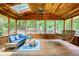 Wood porch with comfortable seating, ceiling fans, skylights, and a porch swing to relax outdoors at 9685 Cone Ct, Roswell, GA 30075
