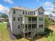 Exterior view of back of house shows a two-story deck and walkout basement with stairs to yard at 127 Sanctuary Ave, Woodstock, GA 30188