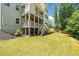 A spacious backyard with a multi-level deck and stairs leading to a lush green lawn, perfect for outdoor activities at 127 Sanctuary Ave, Woodstock, GA 30188