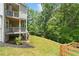 Expansive backyard with a multi-level deck, lush green lawn, and mature trees at 127 Sanctuary Ave, Woodstock, GA 30188