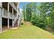 A spacious backyard with a multi-level deck and stairs leading to a lush green lawn, perfect for outdoor activities at 127 Sanctuary Ave, Woodstock, GA 30188
