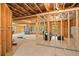 Unfinished basement with exposed wood beams, framing, and natural light at 127 Sanctuary Ave, Woodstock, GA 30188