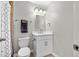 Well-lit bathroom features a modern vanity, mirror, and a shower with decorative curtain at 127 Sanctuary Ave, Woodstock, GA 30188