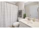 Neat bathroom with a shower and tub, white vanity, decorative mirror and lighting at 127 Sanctuary Ave, Woodstock, GA 30188