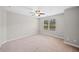 Bedroom with a ceiling fan and a large window providing ample natural light at 127 Sanctuary Ave, Woodstock, GA 30188