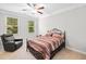 Comfortable bedroom with a large bed, chair, and windows that provide plenty of natural light at 127 Sanctuary Ave, Woodstock, GA 30188