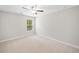 Neutral bedroom featuring carpet, ceiling fan and a window at 127 Sanctuary Ave, Woodstock, GA 30188