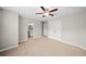 Spacious carpeted bedroom with ceiling fan has an attached bathroom and closet at 127 Sanctuary Ave, Woodstock, GA 30188