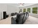 Bonus room boasting luxury seating, theater system and natural lighting at 127 Sanctuary Ave, Woodstock, GA 30188