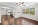 Bright dining area featuring hardwood floors, ceiling fan, and large windows with natural light and open to the kitchen at 127 Sanctuary Ave, Woodstock, GA 30188