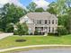 Beautiful two-story home features a well-manicured lawn, lush landscaping, and a brick and stone facade at 127 Sanctuary Ave, Woodstock, GA 30188