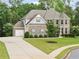 Beautiful two-story home boasts an attached two-car garage and a professionally landscaped yard at 127 Sanctuary Ave, Woodstock, GA 30188
