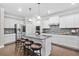 Modern kitchen with white cabinets, stainless steel appliances, a large island, and hardwood floors at 127 Sanctuary Ave, Woodstock, GA 30188
