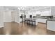 Open concept kitchen with stainless steel appliances, a large island, and views of the dining area at 127 Sanctuary Ave, Woodstock, GA 30188